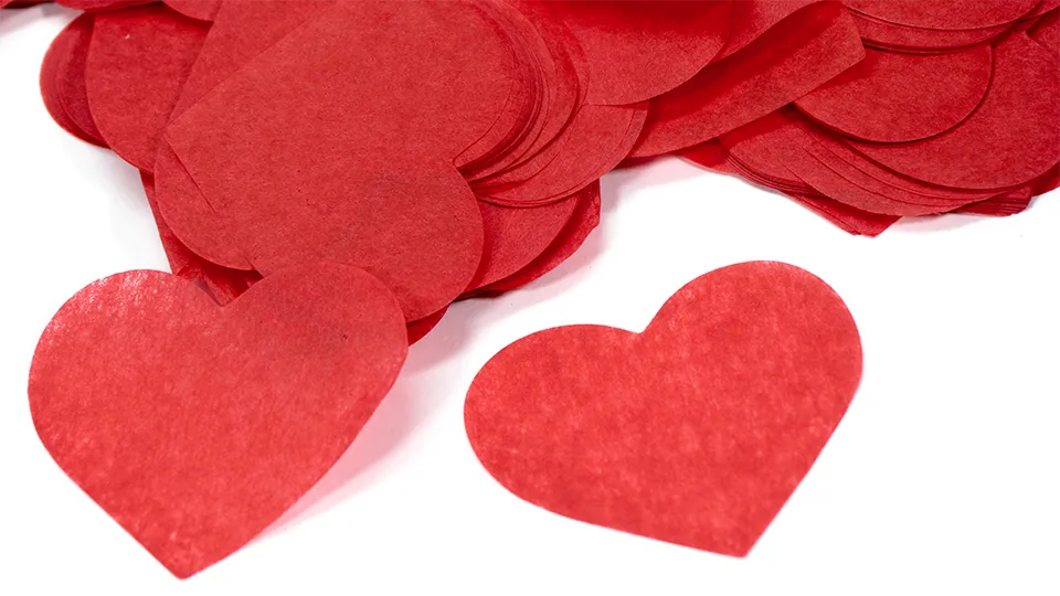 Custom Heart Pro Fetti in a pile with one set out in front. Background for the Hero text on the page.